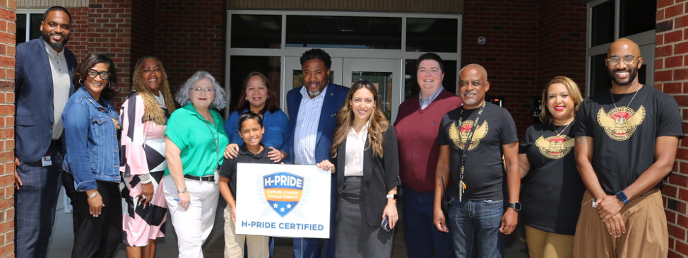 Superintendent and staff holding HPride Sign